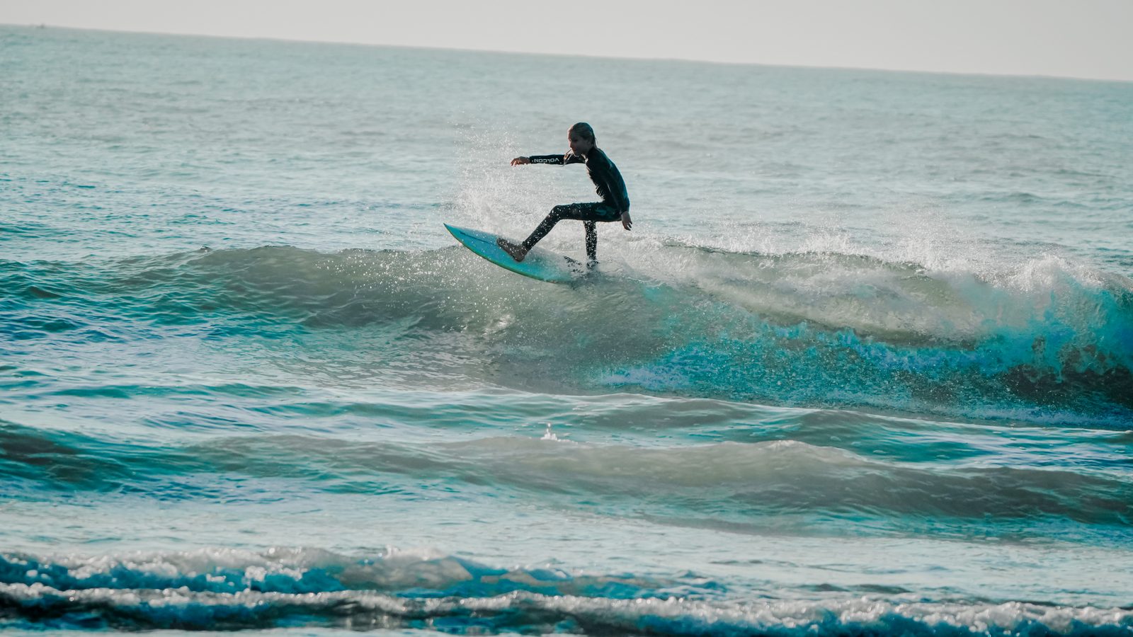 Surfer riding down the line